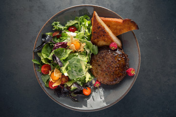 Burger salad. Meat dish of juicy beef patties, lettuce, vegetables, toast.