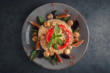 Risotto with mushrooms, figs and sweet pepper stuffed with meat and cheese. Meat dish.