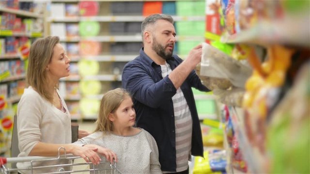Shopping Day Of A Modern Family. Family of Three Spending A Shopping Weekend Together In A Modern Mall.