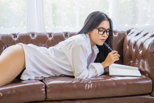 Sexy Business Woman Or Secretary Put Glasses Reading Diary Wearing White Shirt Big Breast Sitting Rest On Sofa Work At Home