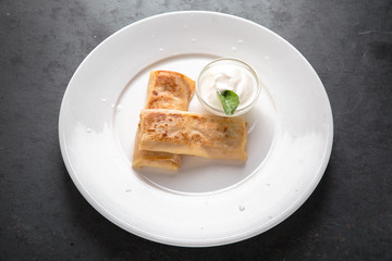 Healthy breakfast. Pancakes stuffed with cottage cheese, or potatoes, or meat, or cabbage