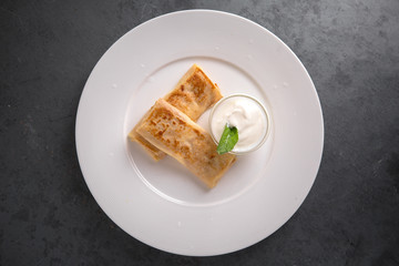 Healthy breakfast. Pancakes stuffed with cottage cheese, or potatoes, or meat, or cabbage