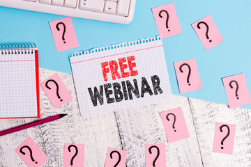 Text sign showing Free Webinar. Business photo showcasing Lecture Workshop Seminar that is transmitted over the Web Writing tools, computer stuff and math book sheet on top of wooden table