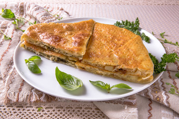 Pies with potatoes, cottage cheese, cabbage and apple. Plateau with sliced vertuta.