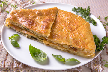 Pies with potatoes, cottage cheese, cabbage and apple. Plateau with sliced vertuta.