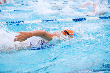 Fototapeta na wymiar Freestyle swimmers racing in a pool