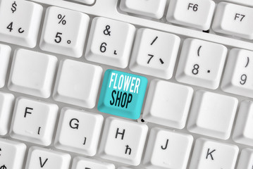 Writing note showing Flower Shop. Business concept for where cut flowers are sold with decorations for gifts White pc keyboard with note paper above the white background
