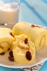 view raisin cakes with cut out section and cup of milk in a sunny morning vertical composition
