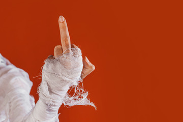 Halloween, costume image. The mummy's hand in bandages making gestures
