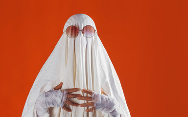 Happy Halloween. Cute funny Ghost on a bright orange background