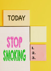 Word writing text Stop Smoking. Business photo showcasing Discontinuing or stopping the use of tobacco addiction Colored empty papers with copy space on the yellow background table