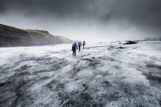 People Hike In A Glacier