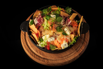 top view on exclusive decorated cheese and greens salad over black