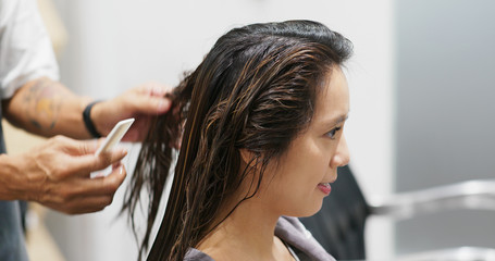Woman having hair treatment in hair salon