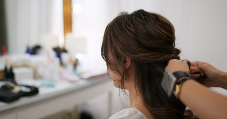 Woman having hair style in beauty salon
