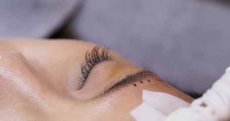 Beautician specialist of permanent makeup making brow microblading tattooing make up