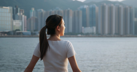 Woman look around the sea view in Hong Kong