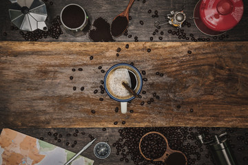 Brown coffee beans And a cup of hot coffee placed on a wooden table. Concept travel with map. Time to relax with a cup drink of good coffee. Top view copy space for your text.