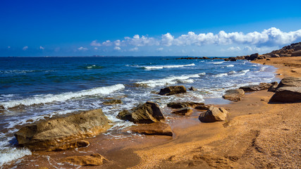 Fototapeta na wymiar Rock fragments on a wild beach