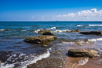 Fototapeta na wymiar Rock fragments on a wild beach