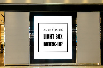 mock up blank vertical light box on panel of shop