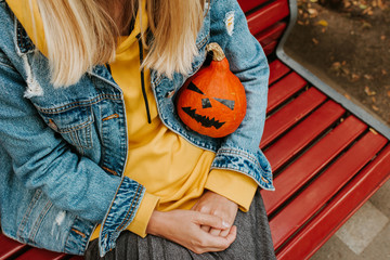 Halloween pumpkin. Woman holding a scary face pumpkin. Happy Halloween party holiday. Celebrate...