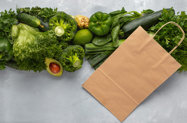 Paper bag with green vegetables. Purchase healthy vegan and vegetarian food