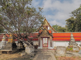 Obraz premium view on walk way in front of Thai buddhist temple with cloudy sky background, Wat Khanon Nang Yai, Amphur Photharam, Ratchaburi Province, Thailand.