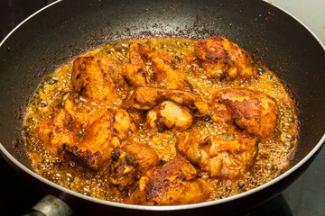 Marinated chicken frying in oil in a pan. Kerala style frying 