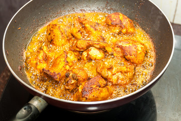 Marinated chicken frying in oil in a pan. Kerala style frying 
