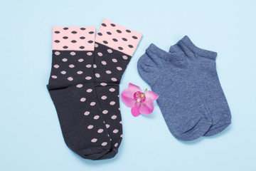 Two pair of women socks on blue background.