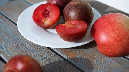 red plumes and peaches on a plate