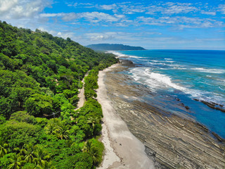 Lush Tropical Beach Paradise with blue water, great waves and rock formations in Malpais / Santa...