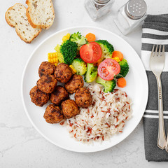 Homemade meatballs with fried rice and broccoli salad, portion for lunch or dinner. Top view.