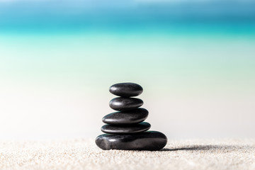 Fototapeta na wymiar Stack of zen stones on sand beach