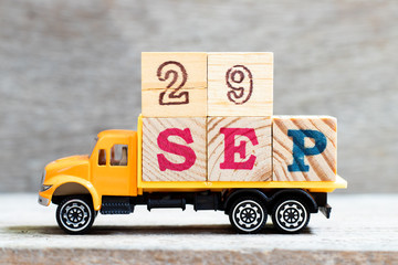 Truck hold letter block in word 29sep on wood background (Concept for date 29 month september)