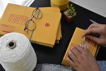 There is a box, a box, a double buffer and scissors in the parcel. They are on the black table.