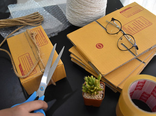 There is a box, a box, a double buffer and scissors in the parcel. They are on the black table.