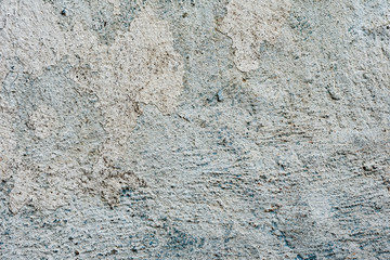 Texture of a concrete wall with cracks and scratches which can be used as a background