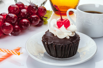 Chocolate cupcakes with whipped cream and cherry