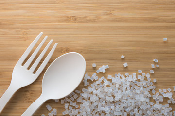 Biodegradable plastic pellets, spoon and fork made from starch and renewable sources