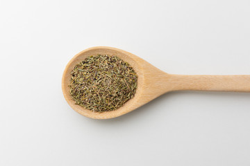 Top view of dry rosemary in wooden spoon white background isolate