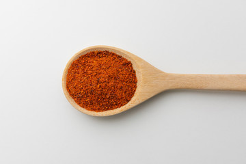 Top view of paprika in wooden spoon white background isolate