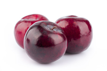 Obraz premium ripe red plum on white background