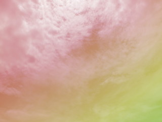 Sky and cloud subtle background with a pastel colored pink and orange gradient. 