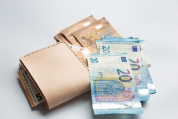 Leather wallet with euro money bill on white background