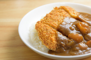 A deep fried pork cutlet topped with Japanese curry and rice