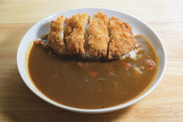 A deep fried pork cutlet topped with Japanese curry and rice