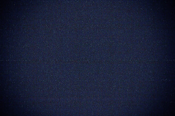 abstract background of grain or noise from digital camera sensor after increasing exposure by software with vignette appearing on the corners, static TV noise, poor signal