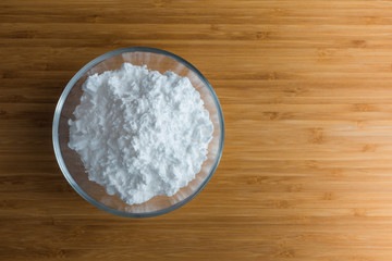 Fototapeta na wymiar Top view tapioca starch powder in wooden bowl background isolate
